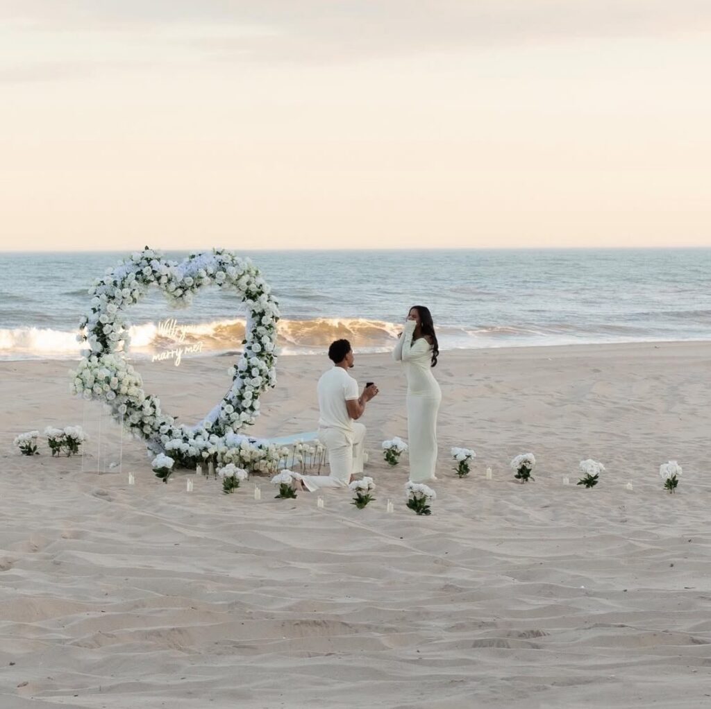 romantic beach proposal flowers set up